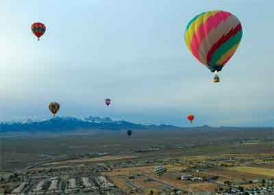 Hot air balloons add a bit of color to the grey skies over Mesquite on Saturday during the annual Hot Air Balloon Festival. PHOTO BY CATHERINE ELLERTON/Moapa Valley Progress.