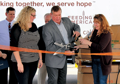 Cutting a cerebmonial ribbon for the new Three Square Mobile Food Pantry are l to r Bren McClean, Congressman Cresent Hardy, and County Commissioner Marilyn Kirkpatrick. PHOTO BY MAGGIE MCMURRAY/Moapa Valley Progress.