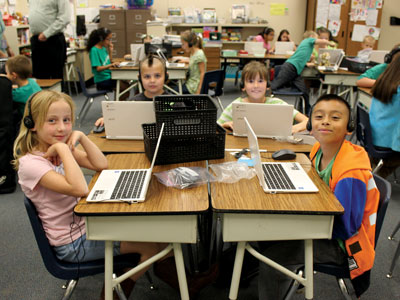 Perkins students l to r Alison Farino, Oliver DeMille, Sydney Parashonts, and Marco Ramirez enjoy working together online in Mrs. Lana Hess's 3rd grade classroom. PHOTO BY MAGGIE MCMURRAY/Moapa Valley Progress.