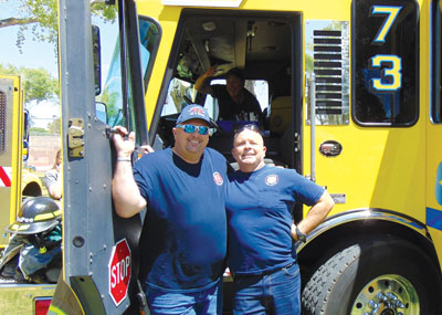 Local volunteer firefighters Joe Jackson (left) and Otto Foster (right) enjoyed giving tours of the engine at the First Responder Appreciation Event on Saturday at the Overton Park. PHOTO BY STEPHANIE BUNKER/Moapa Valley Progress.