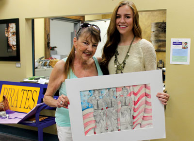 MVHS student Abigail Wallace receives an award from local VFW Auxiliary president Linda Brommer for winning a Patriotic Art Contest at both the local and district level. PHOTO BY MAGGIE MCMURRAY/Moapa Valley Progress.