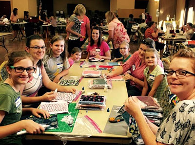 More than 75 local women and girls gathered last week at the Overton Senior Center to make feminine hygiene kits for needy girls in third world countries. PHOTO COURTESY OF LORRI RUST.