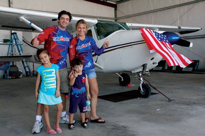 The Vassilev family pose in their Perkins Field Airport hangar which will be the new home of a skydiving operation which promises to target a world-wide  clientele. Pictured are business owners Sammy and Iva Vassilev and their children Jasmine (6) and Anthony (4). PHOTO BY VERNON ROBISON/Moapa Valley Progress.