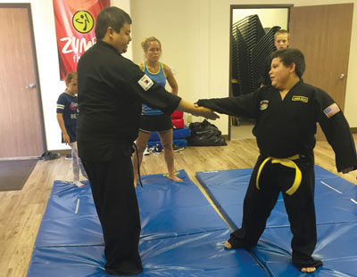 Local martial arts instructor Nick Yamashita instructs a local youth during a special workshop on Saturday which featured world champion Safarri Jessop. PHOTO BY MACY MORGAN/Moapa Valley Progress.