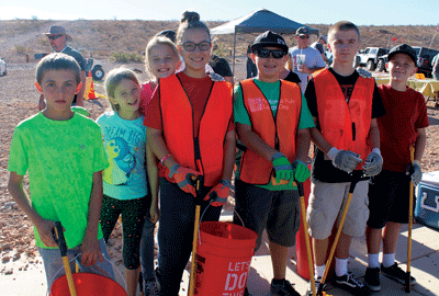Youngsters participate in Public Lands Day at Logandale Trails area on Saturday. Pictured l to r area Chase Dowden, Alyssa Blair, 10, Josie Gerken, 10, Aliyana Prewitt, 13, Brendan Prewitt, 10, Cole Gerken, 12, and Dylan Gerkin, 14  all outfitted and ready to clean up. PHOTO BY MAGGIE MCMURRAY/Moapa Valley Progress.