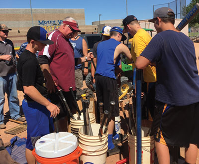 New MVHS Baseball coach Ed McCann (center) works with players in organizing supplies from the team shed during a project at the MVHS Baseball field on Saturday morning. PHOTO COURTESY OF SUSIE GUESSMAN.