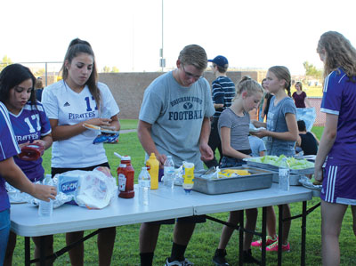 Attendees prepare their hot dogs and hamburgers at the All Sports Kickoff event held on Monday, August 29. PHOTO BY MAGGIE MCMURRAY/Moapa Valley Progress.