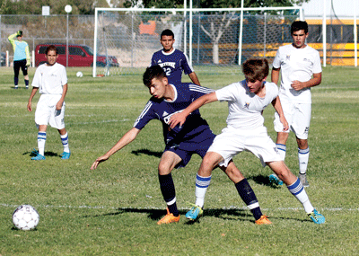 MVHS player Josh Lee struggles with a Cheyenne opponent for possession of the ball during last week’s home game. PHOTO BY DOROTHY ELY-SCOTT/Moapa Valley Progress.
