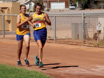 MVHS Cross Country runners Anna Stratton and Emma Thompson run close together during the Moapa Valley Invitational held on Saturday morning at the Logandale Fairgrounds. PHOTO BY VERNON ROBISON/Moapa Valley Progress.