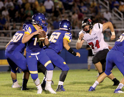 Pirate quarterback and MVHS junior Daxton Longman drops back to make a pass in the game last week against Hurricane, Utah. PHOTOO BY VERNON ROBISON/Moapa Valley Progress.