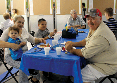 Jose and Edith Gomez enjoy breakfast with their grandchildren Dave Masego and Vincent Macias during the Grandparents Day event at Grant Bowler elementary last week. PHOTO BY MAGGIE MCMURRAY/Moapa Valley Progress.