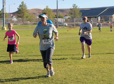 A group of last year’s Kill Hill Challenge participants reach the finish line in the Fun Run event. PHOTO BY MAGGIE MCMURRAY/Moapa Valley Progress.