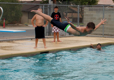Mack Lyon Middle School student Fox Soderquist competes in a belly flop contest at the school’s Back To School party held last week. PHOTO BY MAGGIE MCMURRAY/Moapa Valley Progress.