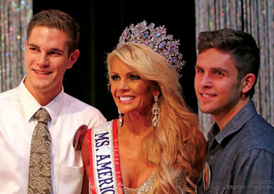 Former Logandale resident Tracy Rodgers poses with her sons Derrick Bush (left) and Damon Bush (right) after winning the Ms. America International title on Saturday.