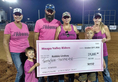 Organizers of the Tough Enough to Wear Pink event present a check for $25,000 to Robbie Lindsay and her family to help with her breast cancer treatment.