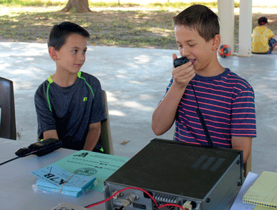 Cub Scouts Josh and Isaac Linford use a HAM Radio to try to contact other Scouts around the world during the 2016 Jamboree on the Air last week. PHOTO BY MAGGIE MCMURRAY/Moapa Valley Progress.