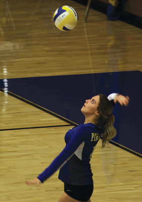 MVHS senior Halle Bennett winds up for a serve in a home match against the Bulldogs last week. PHOTO BY ADDIE ROBISON/Moapa Valley Progress.